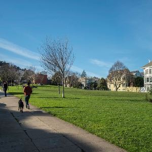 Dog and owner on trail at Duboce Park Dog Play Area