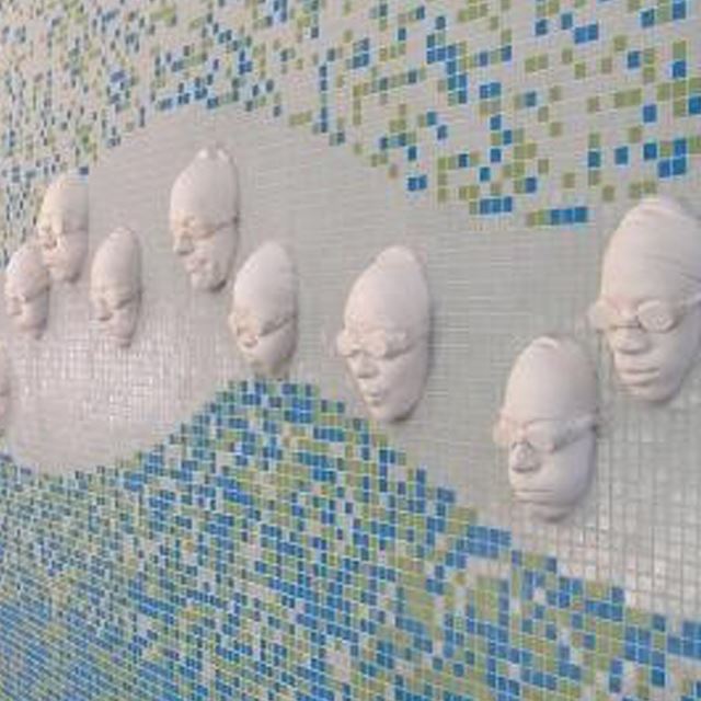 Wall art of swimmers' faces