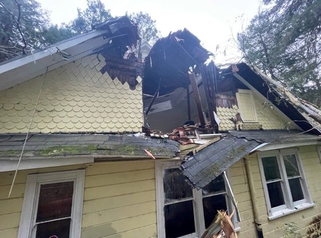 Large hole in clubhouse roof shown from outside