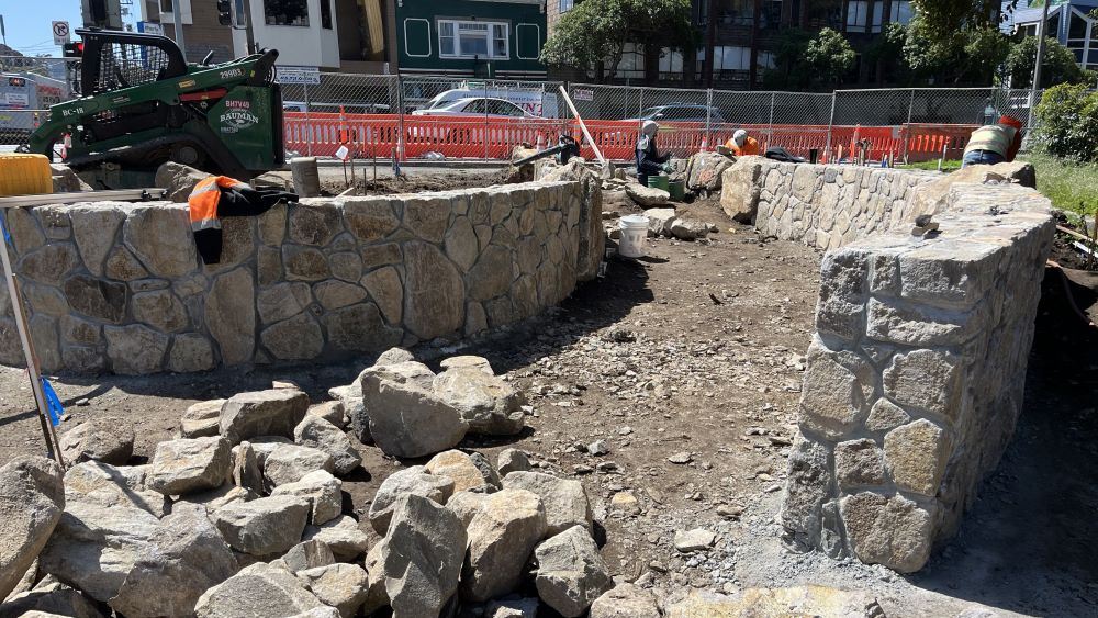 Rock walls being cut and installed