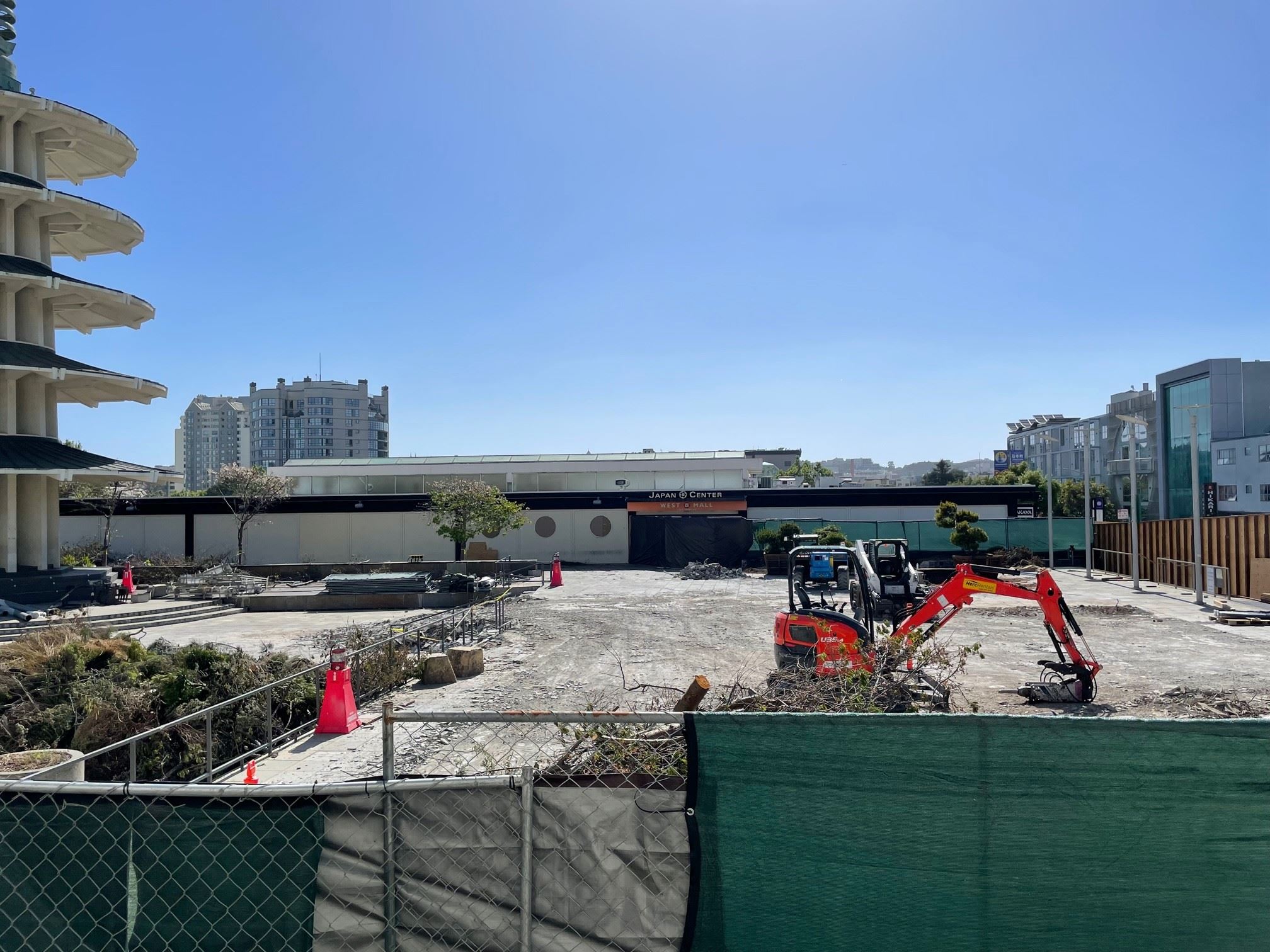 Excavators remove cement at the plaza